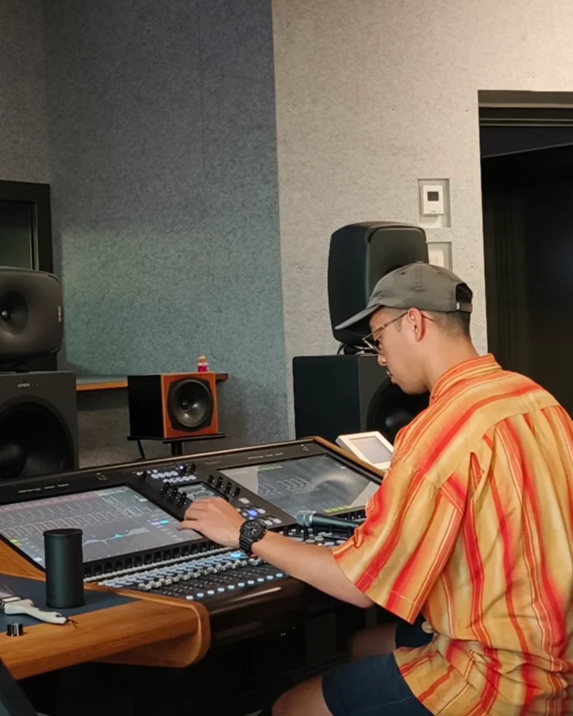 Kevin Abundo controlling the mixer in recording studio